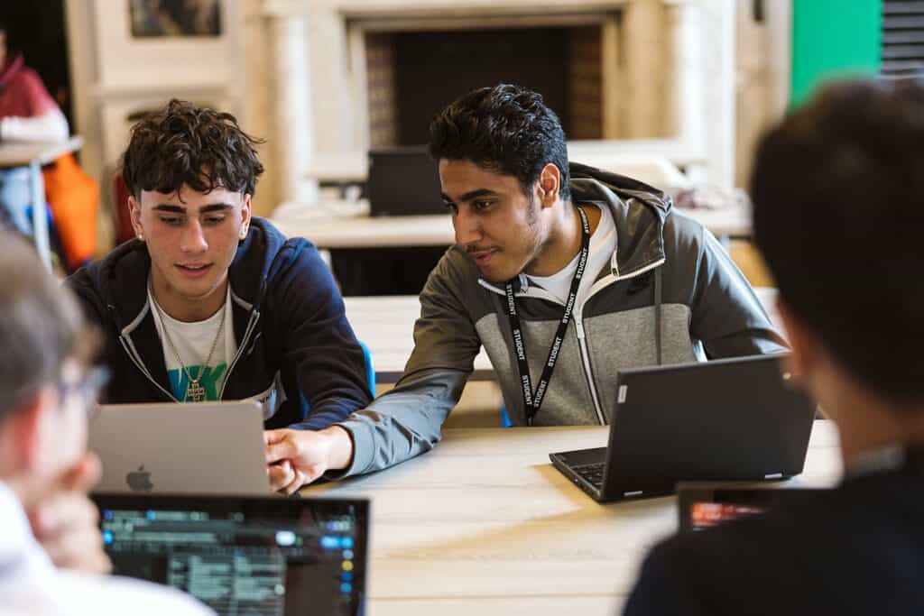 Business students looking at laptop