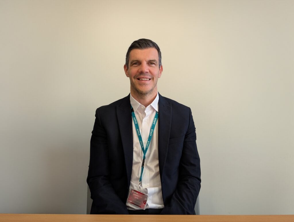 A photo of Gary Dixon smiling to the camera