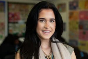 girl with arms folded smiling