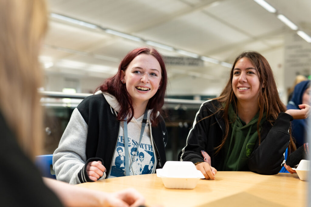 Students laughing at  a table